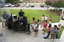 Coach Paul Hewitt grills hamburgers as AXO sisters watch Thursday night.  AXO was the winning sorority for the basketball attendance competition.

Filename: crw_0047_std.jpg
Aperture: f/6.3
Shutter Speed: 1/80
Body: Canon EOS DIGITAL REBEL
Lens: Sigma 15-30mm f/3.5-4.5 EX Aspherical DG DF