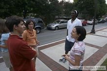 Suzannah Gill, Casey Taylor and Clarence Moore have a conversation after Coach Hewitt's cookout at AXO.  AXO was the winning sorority for the basketball attendance competition.

Filename: crw_0096_std.jpg
Aperture: f/6.3
Shutter Speed: 1/80
Body: Canon EOS DIGITAL REBEL
Lens: Sigma 15-30mm f/3.5-4.5 EX Aspherical DG DF