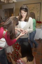 Kathlyn Parr, in pink, helps Jessica Liu dress Meghan Doege in a wrapping-paper garment at the Alpha Delta Pi Christmas party, Sunday, December 10, 2006.

Filename: SRM_20061210_1835024.jpg
Aperture: f/5.0
Shutter Speed: 1/100
Body: Canon EOS 20D
Lens: Canon EF-S 18-55mm f/3.5-5.6