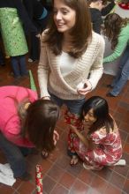 Kathlyn Parr, in pink, helps Jessica Liu dress Meghan Doege in a wrapping-paper garment at the Alpha Delta Pi Christmas party, Sunday, December 10, 2006.

Filename: SRM_20061210_1835366.jpg
Aperture: f/5.0
Shutter Speed: 1/100
Body: Canon EOS 20D
Lens: Canon EF-S 18-55mm f/3.5-5.6