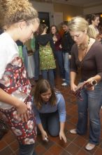 Meredith Clonch (blue) helps Lindsay Fraley dress Anna Matthews in wrapping paper at the Alpha Delta Pi Christmas party, Sunday, December 10, 2006.

Filename: SRM_20061210_1837440.jpg
Aperture: f/5.0
Shutter Speed: 1/100
Body: Canon EOS 20D
Lens: Canon EF-S 18-55mm f/3.5-5.6