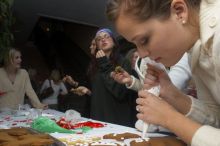 Lauren Fletcher puts frosting on a gingerbread man as Allison Grady, Jessica Hensarly, and Lauren Stewart (from right) eat theirs at the Alpha Delta Pi Christmas party, Sunday, December 10, 2006.

Filename: SRM_20061210_1906028.jpg
Aperture: f/7.1
Shutter Speed: 1/100
Body: Canon EOS 20D
Lens: Canon EF-S 18-55mm f/3.5-5.6