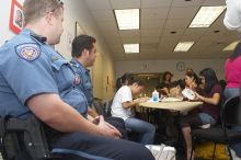 Officers Wesley Schlather and Joshua Martin observe students decorating masks at a domestic violence expressive arts workshop for survivors and friends of survivors of domestic and relationship violence.

Filename: SRM_20061023_1731523.jpg
Aperture: f/5.6
Shutter Speed: 1/100
Body: Canon EOS 20D
Lens: Canon EF-S 18-55mm f/3.5-5.6