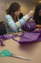 Mae Cortes decorates her mask at a domestic violence expressive arts workshop for survivors and friends of survivors of domestic and relationship violence.

Filename: SRM_20061023_1736145.jpg
Aperture: f/5.6
Shutter Speed: 1/100
Body: Canon EOS 20D
Lens: Canon EF-S 18-55mm f/3.5-5.6