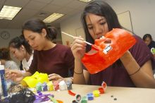 Emily Ng, right, decorates her mask next to Vivian Mai-Tran, left, at a domestic violence expressive arts workshop for survivors and friends of survivors of domestic and relationship violence.

Filename: SRM_20061023_1739208.jpg
Aperture: f/5.6
Shutter Speed: 1/100
Body: Canon EOS 20D
Lens: Canon EF-S 18-55mm f/3.5-5.6