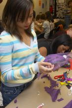 Mae Cortes decorates her mask at a domestic violence expressive arts workshop for survivors and friends of survivors of domestic and relationship violence.

Filename: SRM_20061023_1803387.jpg
Aperture: f/5.6
Shutter Speed: 1/100
Body: Canon EOS 20D
Lens: Canon EF-S 18-55mm f/3.5-5.6