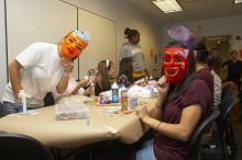 Hannah Yee, left, and Emily Ng show off their masks at a domestic violence expressive arts workshop for survivors and friends of survivors of domestic and relationship violence.

Filename: SRM_20061023_1806106.jpg
Aperture: f/5.6
Shutter Speed: 1/100
Body: Canon EOS 20D
Lens: Canon EF-S 18-55mm f/3.5-5.6