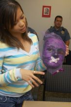 Mae Cortes describes her mask at a domestic violence expressive arts workshop for survivors and friends of survivors of domestic and relationship violence.

Filename: SRM_20061023_1824266.jpg
Aperture: f/5.6
Shutter Speed: 1/100
Body: Canon EOS 20D
Lens: Canon EF-S 18-55mm f/3.5-5.6