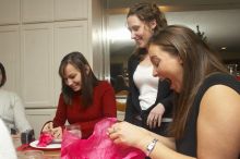 Mandy Mauldin, center, gives presents to Jessica Schreyer, left, and Allison Lear, right, at the Alpha Xi Delta Christmas dinner, Friday, December 4, 2006.

Filename: SRM_20061204_1815284.jpg
Aperture: f/6.3
Shutter Speed: 1/250
Body: Canon EOS 20D
Lens: Canon EF-S 18-55mm f/3.5-5.6