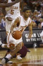 Guard D.J. Augustin, #14.  The longhorns defeated the Texas Southern University (TSU) Tigers 90-50 Tuesday night.

Filename: SRM_20061128_2013408.jpg
Aperture: f/2.8
Shutter Speed: 1/640
Body: Canon EOS-1D Mark II
Lens: Canon EF 80-200mm f/2.8 L