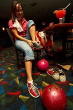 Jessica Schreyer laces up for bowling.  Alpha Xi Delta held a sock hop themed date night at the Austin 300 bowling alley, Thursday night, March 29, 2007.

Filename: SRM_20070329_2019409.jpg
Aperture: f/8.0
Shutter Speed: 1/200
Body: Canon EOS-1D Mark II
Lens: Sigma 15-30mm f/3.5-4.5 EX Aspherical DG DF