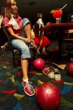 Jessica Schreyer laces up for bowling.  Alpha Xi Delta held a sock hop themed date night at the Austin 300 bowling alley, Thursday night, March 29, 2007.

Filename: SRM_20070329_2019481.jpg
Aperture: f/8.0
Shutter Speed: 1/200
Body: Canon EOS-1D Mark II
Lens: Sigma 15-30mm f/3.5-4.5 EX Aspherical DG DF