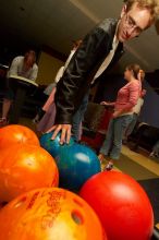 Blake Lindell reaches for a bowling ball.  Alpha Xi Delta held a sock hop themed date night at the Austin 300 bowling alley, Thursday night, March 29, 2007.

Filename: SRM_20070329_2036180.jpg
Aperture: f/8.0
Shutter Speed: 1/200
Body: Canon EOS-1D Mark II
Lens: Sigma 15-30mm f/3.5-4.5 EX Aspherical DG DF