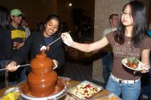 Deby Thomas, left, and Linda Dao enjoying the chocolate fondue.  The Asian Business Students Association (ABSA) hosted a chocolate fondue Friday, January 26, 2007 before heading off to a movie premier.

Filename: SRM_20070126_1626362.jpg
Aperture: f/5.0
Shutter Speed: 1/125
Body: Canon EOS 20D
Lens: Canon EF-S 18-55mm f/3.5-5.6