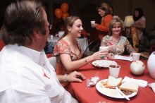 Haley Lyons and her parents sign the Kappa house leasing contract.  Kappa Kappa Gamma (KKG) hosted a parents' weekend barbecue before the UT vs Nebraska football game on Saturday, October 27, 2007 at their sorority house.

Filename: SRM_20071027_1205505.jpg
Aperture: f/8.0
Shutter Speed: 1/250
Body: Canon EOS 20D
Lens: Canon EF-S 18-55mm f/3.5-5.6