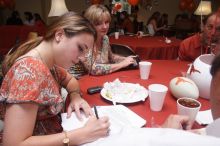 Haley Lyons and her parents sign the Kappa house leasing contract.  Kappa Kappa Gamma (KKG) hosted a parents' weekend barbecue before the UT vs Nebraska football game on Saturday, October 27, 2007 at their sorority house.

Filename: SRM_20071027_1206187.jpg
Aperture: f/8.0
Shutter Speed: 1/250
Body: Canon EOS 20D
Lens: Canon EF-S 18-55mm f/3.5-5.6