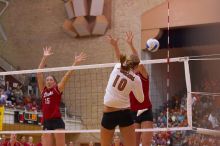 UT sophomore Ashley Engle (#10, S/RS) spikes on Nebraska sophomore Kori Cooper (#15, MB) and Nebraska senior Christina Houghtelling (#3, OH).  The Longhorns defeated the Huskers 3-0 on Wednesday night, October 24, 2007 at Gregory Gym.

Filename: SRM_20071024_1839225.jpg
Aperture: f/3.5
Shutter Speed: 1/400
Body: Canon EOS-1D Mark II
Lens: Canon EF 80-200mm f/2.8 L