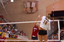 UT sophomore Ashley Engle (#10, S/RS) spikes past Nebraska senior Christina Houghtelling (#3, OH) as Nebraska senior Tracy Stalls (#11, MB) watches.  The Longhorns defeated the Huskers 3-0 on Wednesday night, October 24, 2007 at Gregory Gym.

Filename: SRM_20071024_1846363.jpg
Aperture: f/4.0
Shutter Speed: 1/400
Body: Canon EOS-1D Mark II
Lens: Canon EF 80-200mm f/2.8 L