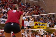 UT junior Lauren Paolini (#3, UTIL) spikes the ball past Nebraska sophomore Rachel Holloway (#12, S) as UT sophomore Ashley Engle (#10, S/RS) and Nebraska senior Sarah Pavan (#9, RS) watch.  The Longhorns defeated the Huskers 3-0 on Wednesday night, Octobe

Filename: SRM_20071024_1914409.jpg
Aperture: f/4.0
Shutter Speed: 1/400
Body: Canon EOS-1D Mark II
Lens: Canon EF 80-200mm f/2.8 L