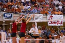 UT sophomore Ashley Engle (#10, S/RS) hits the ball past blockers Nebraska senior Christina Houghtelling (#3, OH) and Nebraska senior Tracy Stalls (#11, MB).  The Longhorns defeated the Huskers 3-0 on Wednesday night, October 24, 2007 at Gregory Gym.

Filename: SRM_20071024_1928502.jpg
Aperture: f/4.0
Shutter Speed: 1/400
Body: Canon EOS-1D Mark II
Lens: Canon EF 80-200mm f/2.8 L