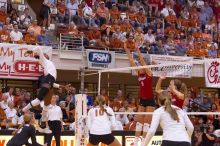 UT sophomore Destinee Hooker (#21, OH) floats, waiting for the spike, as UT senior Alyson Jennings (#16, L), UT sophomore Ashley Engle (#10, S/RS), UT senior Michelle Moriarty (#4, S) and Nebraska senior Sarah Pavan (#9, RS) watch.  The Longhorns defeated

Filename: SRM_20071024_1956083.jpg
Aperture: f/4.0
Shutter Speed: 1/400
Body: Canon EOS-1D Mark II
Lens: Canon EF 80-200mm f/2.8 L