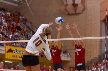 UT sophomore Ashley Engle (#10, S/RS) spikes the ball past Nebraska senior Tracy Stalls (#11, MB) and Nebraska senior Christina Houghtelling (#3, OH).  The Longhorns defeated the Huskers 3-0 on Wednesday night, October 24, 2007 at Gregory Gym.

Filename: SRM_20071024_1957545.jpg
Aperture: f/4.0
Shutter Speed: 1/400
Body: Canon EOS-1D Mark II
Lens: Canon EF 80-200mm f/2.8 L