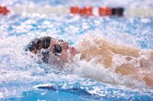 UT sophomore Alan Maher competed in the second heat of the 100 yard backstroke with a time of 51.88.  The University of Texas Longhorns defeated The University of Georgia Bulldogs 157-135 on Saturday, January 12, 2008.

Filename: SRM_20080112_1120520.jpg
Aperture: f/2.8
Shutter Speed: 1/400
Body: Canon EOS-1D Mark II
Lens: Canon EF 300mm f/2.8 L IS