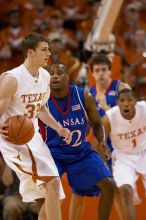 KU senior Darnell Jackson (#32, Forward) guards UT junior Connor Atchley (#32, F/C).  The University of Texas (UT) Longhorns defeated the University of Kansas Jayhawks 72-69 in Austin, Texas on Monday, February 11, 2008.

Filename: SRM_20080211_2017460.jpg
Aperture: f/2.8
Shutter Speed: 1/640
Body: Canon EOS 20D
Lens: Canon EF 300mm f/2.8 L IS