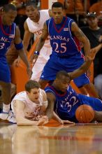 UT junior Connor Atchley (#32, F/C) and KU senior Darnell Jackson (#32, Forward) scramble for the ball.  The University of Texas (UT) Longhorns defeated the University of Kansas Jayhawks 72-69 in Austin, Texas on Monday, February 11, 2008.

Filename: SRM_20080211_2032327.jpg
Aperture: f/2.8
Shutter Speed: 1/640
Body: Canon EOS 20D
Lens: Canon EF 300mm f/2.8 L IS