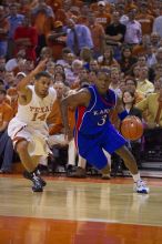 UT sophomore D.J. Augustin (#14, G) defends KU senior Russell Robinson (#3, Guard).  The University of Texas (UT) Longhorns defeated the University of Kansas Jayhawks 72-69 in Austin, Texas on Monday, February 11, 2008.

Filename: SRM_20080211_2040423.jpg
Aperture: f/2.8
Shutter Speed: 1/640
Body: Canon EOS-1D Mark II
Lens: Canon EF 80-200mm f/2.8 L