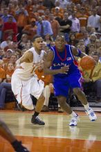 UT sophomore D.J. Augustin (#14, G) defends KU senior Russell Robinson (#3, Guard).  The University of Texas (UT) Longhorns defeated the University of Kansas Jayhawks 72-69 in Austin, Texas on Monday, February 11, 2008.

Filename: SRM_20080211_2040466.jpg
Aperture: f/2.8
Shutter Speed: 1/640
Body: Canon EOS-1D Mark II
Lens: Canon EF 80-200mm f/2.8 L