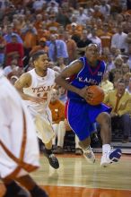 UT sophomore D.J. Augustin (#14, G) defends KU senior Russell Robinson (#3, Guard).  The University of Texas (UT) Longhorns defeated the University of Kansas Jayhawks 72-69 in Austin, Texas on Monday, February 11, 2008.

Filename: SRM_20080211_2040487.jpg
Aperture: f/2.8
Shutter Speed: 1/640
Body: Canon EOS-1D Mark II
Lens: Canon EF 80-200mm f/2.8 L