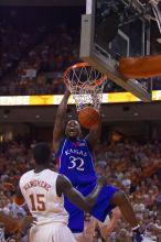 KU senior Darnell Jackson (#32, Forward) dunks over UT freshman Alexis Wangmene (#15, F/C) and UT junior Connor Atchley (#32, F/C).  The University of Texas (UT) Longhorns defeated the University of Kansas Jayhawks 72-69 in Austin, Texas on Monday, February 11, 2008.

Filename: SRM_20080211_2046080.jpg
Aperture: f/2.8
Shutter Speed: 1/640
Body: Canon EOS-1D Mark II
Lens: Canon EF 80-200mm f/2.8 L