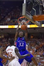 KU senior Darnell Jackson (#32, Forward) dunks over UT freshman Alexis Wangmene (#15, F/C) and UT junior Connor Atchley (#32, F/C).  The University of Texas (UT) Longhorns defeated the University of Kansas Jayhawks 72-69 in Austin, Texas on Monday, February 11, 2008.

Filename: SRM_20080211_2046089.jpg
Aperture: f/2.8
Shutter Speed: 1/640
Body: Canon EOS-1D Mark II
Lens: Canon EF 80-200mm f/2.8 L