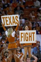 UT Cheerleaders rallying the fans at the Kansas game.  The University of Texas (UT) Longhorns defeated the University of Kansas Jayhawks 72-69 in Austin, Texas on Monday, February 11, 2008.

Filename: SRM_20080211_2052124.jpg
Aperture: f/2.8
Shutter Speed: 1/640
Body: Canon EOS 20D
Lens: Canon EF 300mm f/2.8 L IS