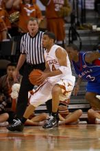 UT junior A.J. Abrams (#3, G) playing defense against a Kansas player.  The University of Texas (UT) Longhorns defeated the University of Kansas Jayhawks 72-69 in Austin, Texas on Monday, February 11, 2008.

Filename: SRM_20080211_2054303.jpg
Aperture: f/2.8
Shutter Speed: 1/640
Body: Canon EOS 20D
Lens: Canon EF 300mm f/2.8 L IS