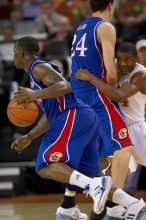 UT sophomore Justin Mason (#24, G) gets picked off by KU senior Sasha Kaun (#24, Center).  The University of Texas (UT) Longhorns defeated the University of Kansas Jayhawks 72-69 in Austin, Texas on Monday, February 11, 2008.

Filename: SRM_20080211_2124528.jpg
Aperture: f/2.8
Shutter Speed: 1/640
Body: Canon EOS 20D
Lens: Canon EF 300mm f/2.8 L IS