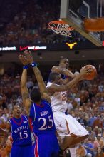 UT sophomore Justin Mason (#24, G) attempts a shot over KU junior Brandon Rush (#25, Guard) and KU junior Mario Chalmers (#15, Guard).  The University of Texas (UT) Longhorns defeated the University of Kansas Jayhawks 72-69 in Austin, Texas on Monday, February 11, 2008.

Filename: SRM_20080211_2128263.jpg
Aperture: f/2.8
Shutter Speed: 1/640
Body: Canon EOS-1D Mark II
Lens: Canon EF 80-200mm f/2.8 L