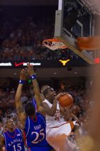 UT sophomore Justin Mason (#24, G) attempts a shot over KU junior Brandon Rush (#25, Guard) and KU junior Mario Chalmers (#15, Guard).  The University of Texas (UT) Longhorns defeated the University of Kansas Jayhawks 72-69 in Austin, Texas on Monday, February 11, 2008.

Filename: SRM_20080211_2128264.jpg
Aperture: f/2.8
Shutter Speed: 1/640
Body: Canon EOS-1D Mark II
Lens: Canon EF 80-200mm f/2.8 L