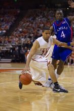 UT sophomore D.J. Augustin (#14, G) makes a drive past KU sophomore Sherron Collins (#4, Guard).  The University of Texas (UT) Longhorns defeated the University of Kansas Jayhawks 72-69 in Austin, Texas on Monday, February 11, 2008.

Filename: SRM_20080211_2142263.jpg
Aperture: f/2.8
Shutter Speed: 1/640
Body: Canon EOS-1D Mark II
Lens: Canon EF 80-200mm f/2.8 L