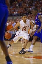 UT sophomore D.J. Augustin (#14, G) makes a drive past KU sophomore Sherron Collins (#4, Guard).  The University of Texas (UT) Longhorns defeated the University of Kansas Jayhawks 72-69 in Austin, Texas on Monday, February 11, 2008.

Filename: SRM_20080211_2145261.jpg
Aperture: f/2.8
Shutter Speed: 1/640
Body: Canon EOS-1D Mark II
Lens: Canon EF 80-200mm f/2.8 L