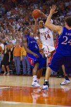 UT sophomore D.J. Augustin (#14, G) takes a shot with KU senior Sasha Kaun (#24, Center) and KU sophomore Sherron Collins (#4, Guard) guarding him.  The University of Texas (UT) Longhorns defeated the University of Kansas Jayhawks 72-69 in Austin, Texas on Monday, February 11, 2008.

Filename: SRM_20080211_2155368.jpg
Aperture: f/2.8
Shutter Speed: 1/640
Body: Canon EOS-1D Mark II
Lens: Canon EF 80-200mm f/2.8 L