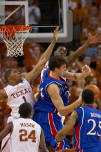 KU senior Sasha Kaun (#24, Center) attempts a shot as UT sophomore Justin Mason (#24, G), UT freshman Gary Johnson (#1, F), and UT sophomore Damion James (#5, G/F) block him.  The University of Texas (UT) Longhorns defeated the University of Kansas Jayhawks 72-69 in Austin, Texas on Monday, February 11, 2008.

Filename: SRM_20080211_2159057.jpg
Aperture: f/2.8
Shutter Speed: 1/640
Body: Canon EOS 20D
Lens: Canon EF 300mm f/2.8 L IS