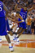 UT sophomore D.J. Augustin (#14, G) drives past KU junior Brandon Rush (#25, Guard) in the Kansas basketball game.  The University of Texas (UT) Longhorns defeated the University of Kansas Jayhawks 72-69 in Austin, Texas on Monday, February 11, 2008.

Filename: SRM_20080211_2159160.jpg
Aperture: f/2.8
Shutter Speed: 1/640
Body: Canon EOS-1D Mark II
Lens: Canon EF 80-200mm f/2.8 L