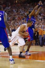 UT sophomore D.J. Augustin (#14, G) drives past KU junior Brandon Rush (#25, Guard) in the Kansas basketball game.  The University of Texas (UT) Longhorns defeated the University of Kansas Jayhawks 72-69 in Austin, Texas on Monday, February 11, 2008.

Filename: SRM_20080211_2159203.jpg
Aperture: f/2.8
Shutter Speed: 1/640
Body: Canon EOS-1D Mark II
Lens: Canon EF 80-200mm f/2.8 L