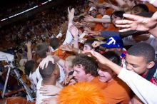 The fans react to the Longhorns' win, rubbing the head of UT freshman Gary Johnson (#1, F) and shaking hands with other players.  The University of Texas (UT) Longhorns defeated the University of Kansas Jayhawks 72-69 in Austin, Texas on Monday, February 11, 2008.

Filename: SRM_20080211_2219061.jpg
Aperture: f/5.6
Shutter Speed: 1/250
Body: Canon EOS-1D Mark II
Lens: Canon EF 16-35mm f/2.8 L
