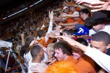 The fans react to the Longhorns' win, rubbing the head of UT freshman Gary Johnson (#1, F) and shaking hands with other players.  The University of Texas (UT) Longhorns defeated the University of Kansas Jayhawks 72-69 in Austin, Texas on Monday, February 11, 2008.

Filename: SRM_20080211_2219082.jpg
Aperture: f/5.6
Shutter Speed: 1/250
Body: Canon EOS-1D Mark II
Lens: Canon EF 16-35mm f/2.8 L