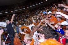 The fans react to the Longhorns' win, shaking hands with UT sophomore Justin Mason (#24, G) and other players.  The University of Texas (UT) Longhorns defeated the University of Kansas Jayhawks 72-69 in Austin, Texas on Monday, February 11, 2008.

Filename: SRM_20080211_2219269.jpg
Aperture: f/5.6
Shutter Speed: 1/250
Body: Canon EOS-1D Mark II
Lens: Canon EF 16-35mm f/2.8 L