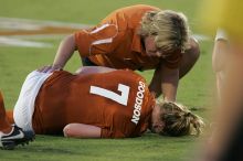 UT freshman Courtney Goodson (#7, Forward and Midfielder) lies on the field injured as her coach checks on her.  The University of Texas women's soccer team tied 0-0 against the Texas A&M Aggies Friday night, September 27, 2008.

Filename: SRM_20080926_1925080.jpg
Aperture: f/4.0
Shutter Speed: 1/200
Body: Canon EOS-1D Mark II
Lens: Canon EF 300mm f/2.8 L IS