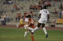 UT sophomore Alisha Ortiz (#12, Forward) gets kicked in the butt by A&M #13.  The University of Texas women's soccer team tied 0-0 against the Texas A&M Aggies Friday night, September 27, 2008.

Filename: SRM_20080926_1929123.jpg
Aperture: f/4.0
Shutter Speed: 1/400
Body: Canon EOS-1D Mark II
Lens: Canon EF 300mm f/2.8 L IS
